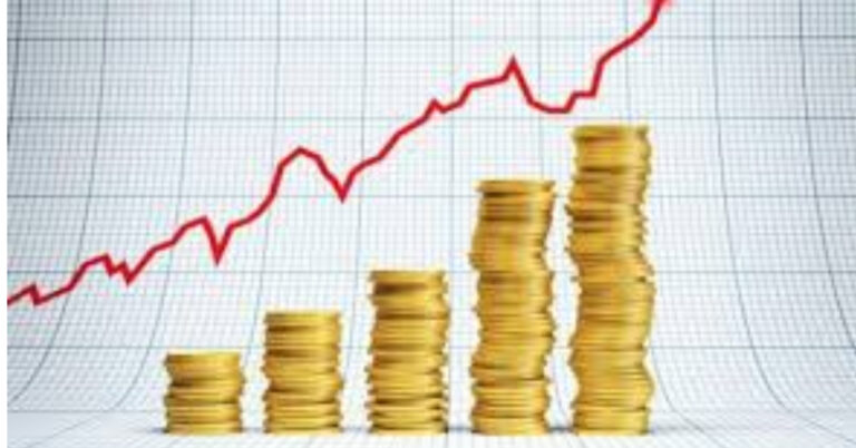 En la foto se ve un gráfico de inflación, con unas monedas y una barra ascendente