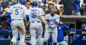 En la foto, Will Smith es recibido por sus compañeros tras pegar jonrón