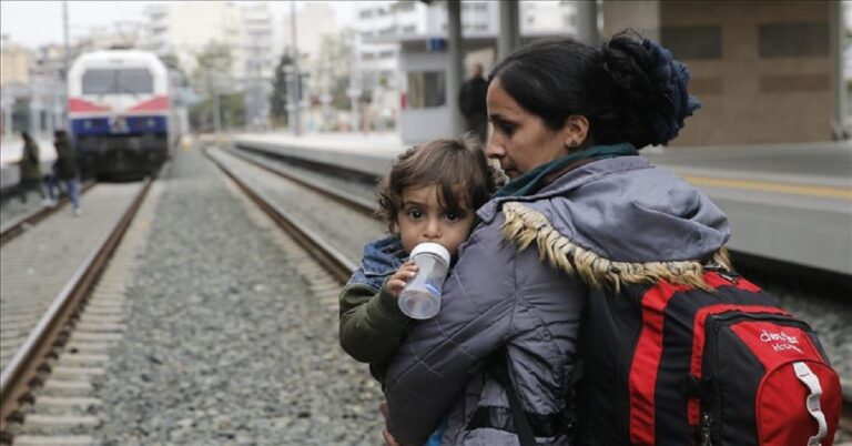 En la foto, una mujer migrante y su niña