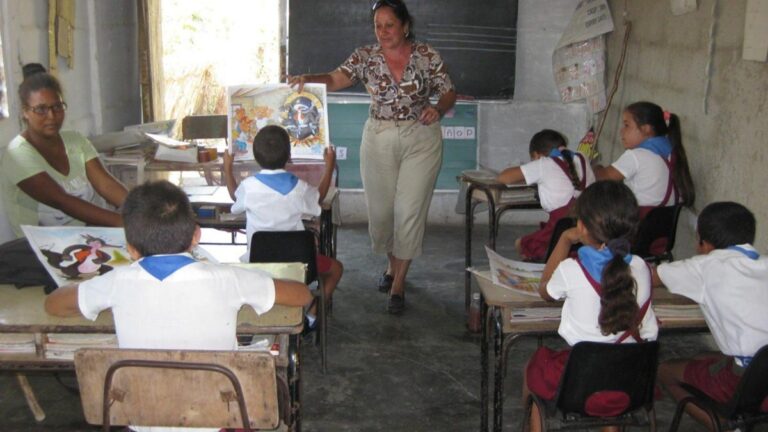 En la foto, una maestra da clases en un aula en Cuba
