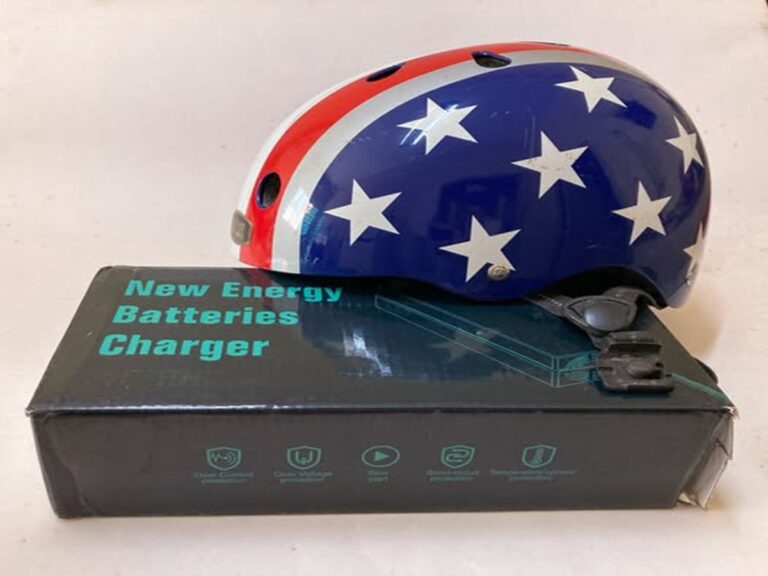 En la foto, un casco de moto y un cargador eléctrico para motos