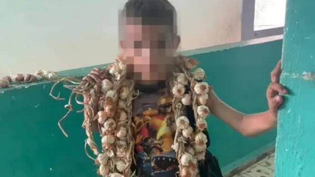 En la foto, un niño cubano vende ajos para ayudar a su familia