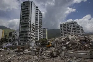 En la foto, Maquinaria pesada remueve escombros en edificios afectados por el doble terremoto del 24 de junio, en Caraballeda (Venezuela