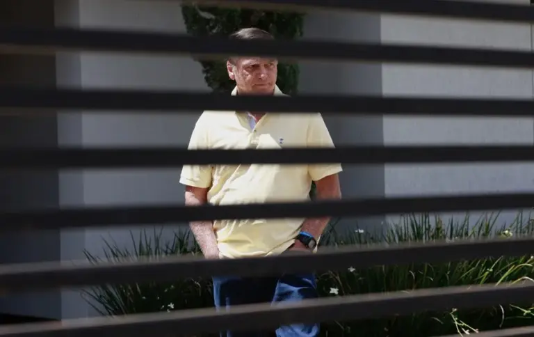 En la foto, El expresidente de Brasil Jair Bolsonaro caminando al interior de su residencia, en Brasilia (Brasil)